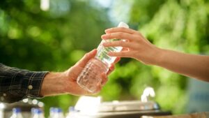 handing over bottle of water